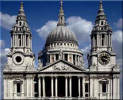 a large white portland stone building with a clock tower in the middle