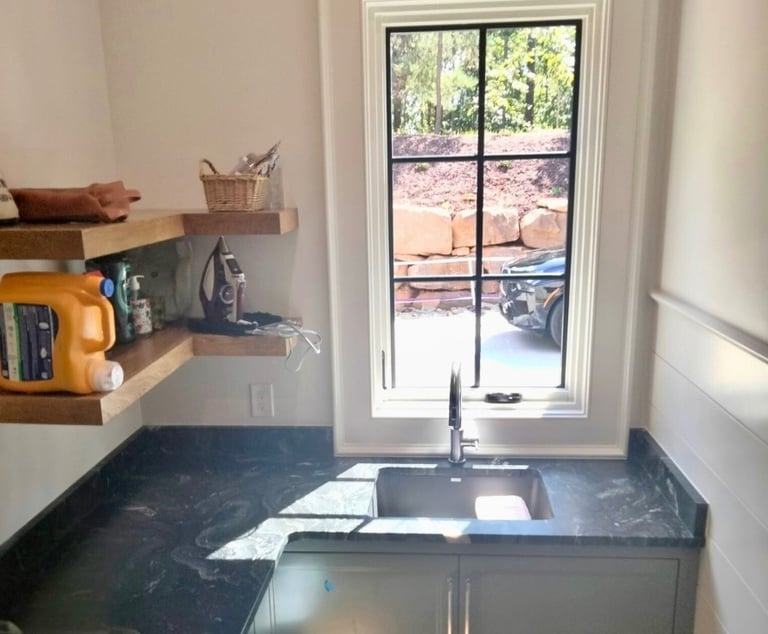 Laundry room sink with dark granite countertop in Asheville, NC