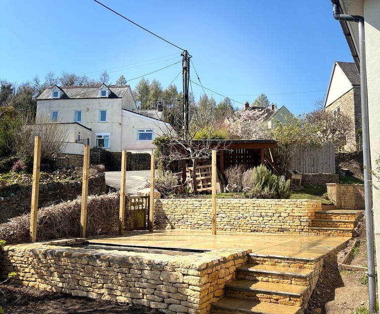 Custom designed garden project with dry stone retaining walls, steps, and patio