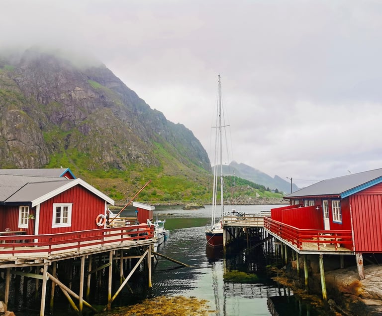 Historic Å fishing village with red cabins and the Jolly Good Times Sailing boat