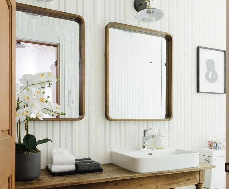 a bathroom with a sink and a wooden table