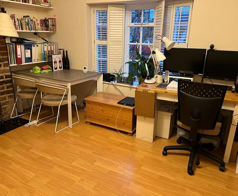 Existing home office with a lot of clutter on display
