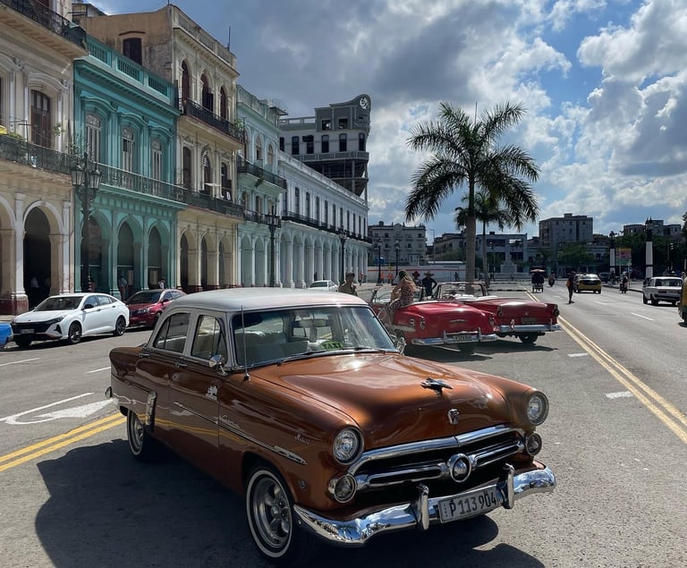 a classic car parked on the side of a street cuba