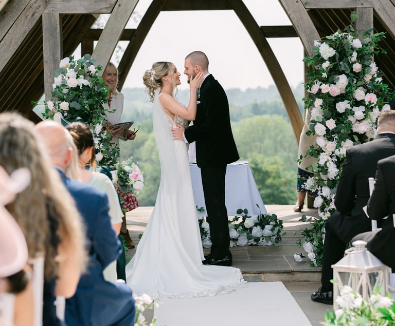 Couple at the altar during their wedding at Highley Manor, West Sussex