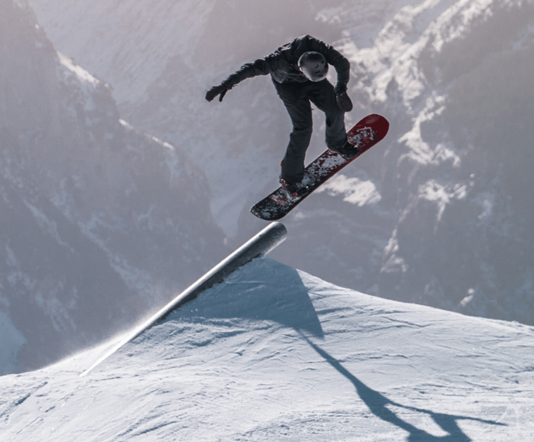 a snowboarder is doing a trick on a snowboard