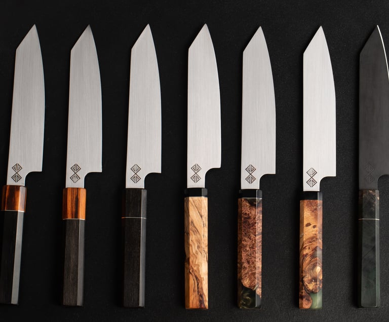a set of five baltic blades chef knives and knives on a black background