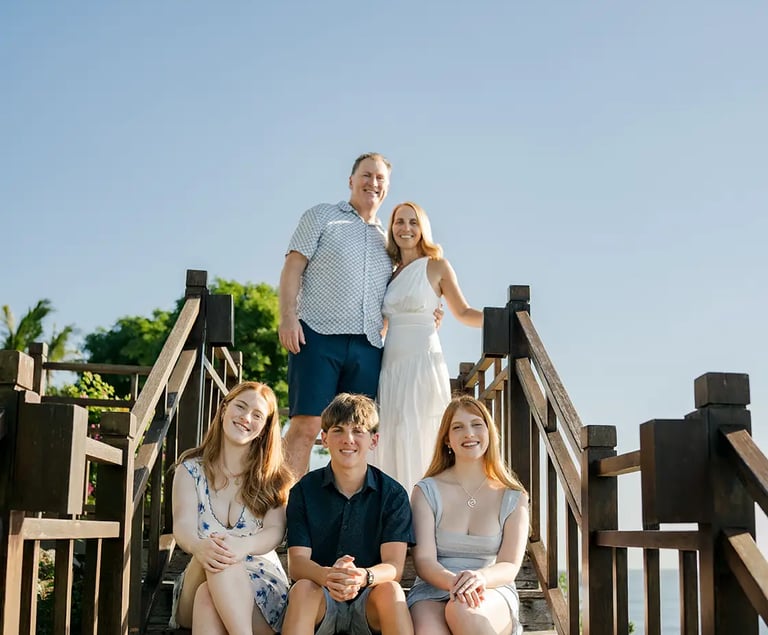 Family gathered at the ocean viewpoint during a family photography session at AYANA Resort Bali