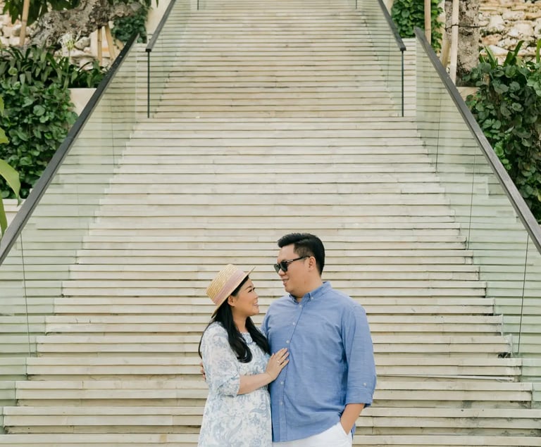 Couple embracing on the Grand Staircase at The Apurva Kempinski Bali