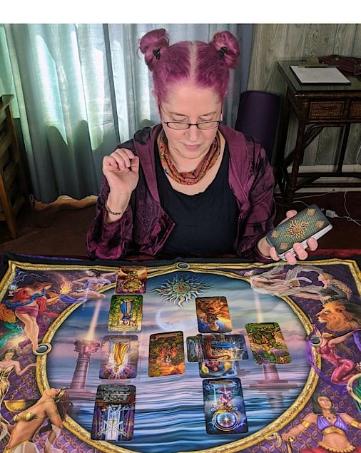 Renee looking at Tarot Cards on colorful Reading Cloth!