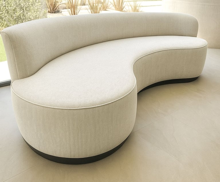 Curved light-gray upholstered sofa with textured fabric and black base in modern room with natural light — by Solo Home Decor