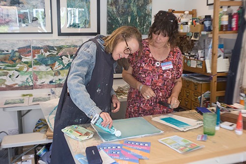 Image of two artists painting