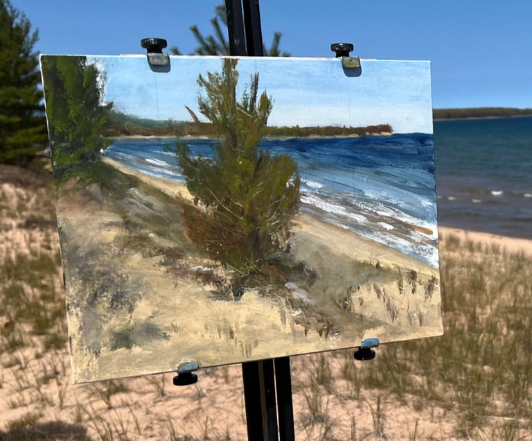 An original open-air plein air oil painting of the Lake Superior shoreline resting on a wooden field