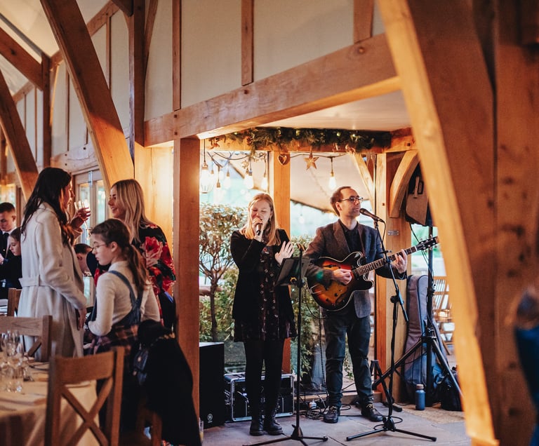 singer and guitarist in wedding barn for reception