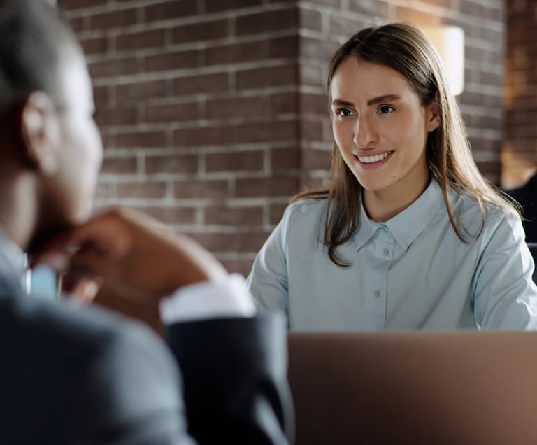 a woman in a blue shirt and a man in a suit and tie