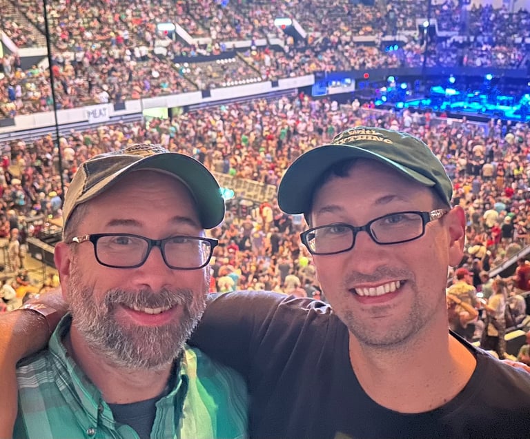 Mike and Chris Howdyshell in a large, crowded stadium