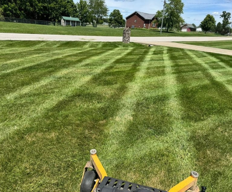 Freshly mowed lawn with clean striping from professional lawn care services by Valor Home Professionals