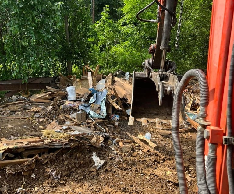 Property cleanout and demolition debris removal using heavy equipment by Valor Home Professionals