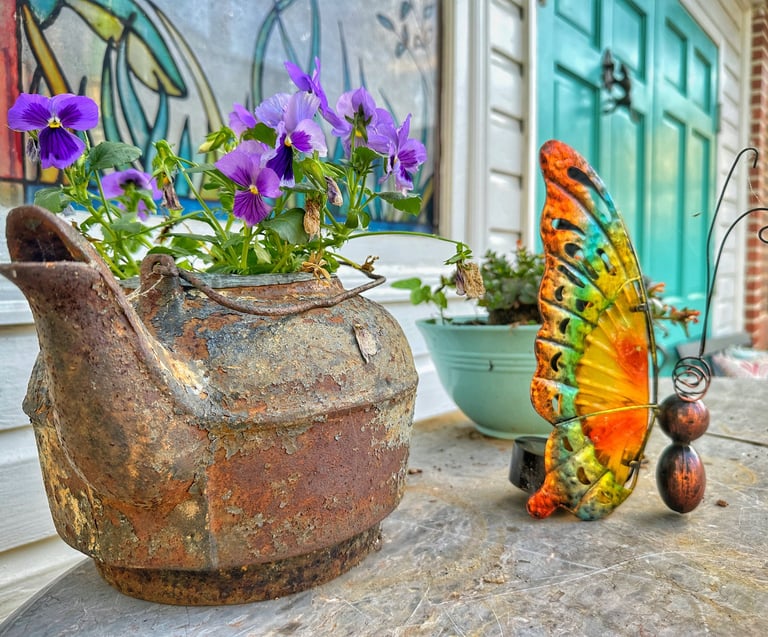 detail of old kettle with flowers growing inside 2123 rivermont