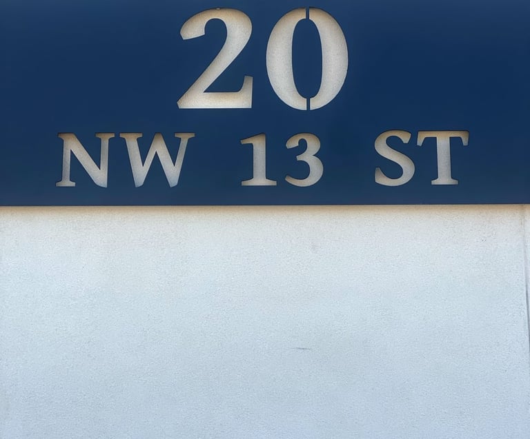 20 NW 13th St sign on exterior of our office