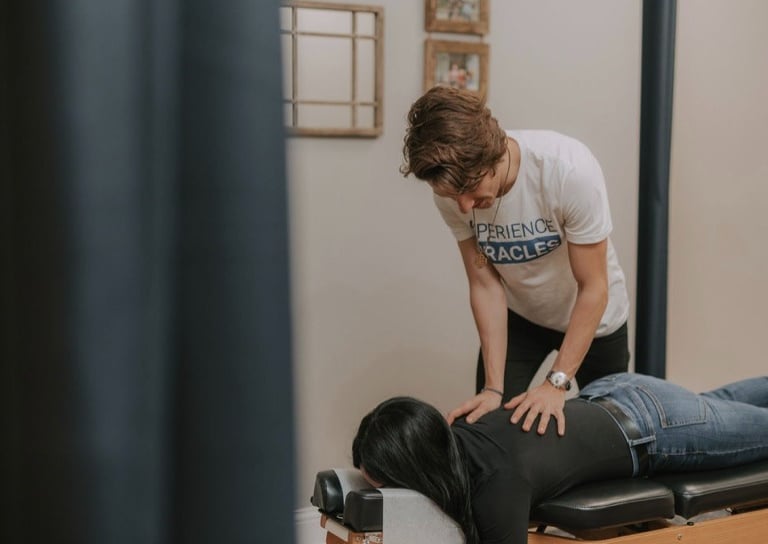 Pregnant woman receiving gentle prenatal chiropractic adjustment in Franklin TN