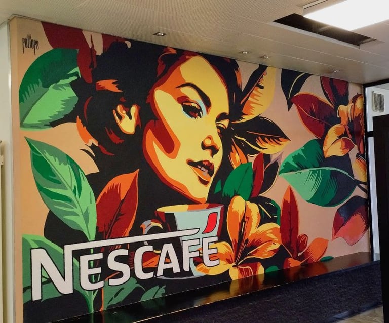 Colorful indoor mural with female face and Nescafé logo, artistic work by Poliops.