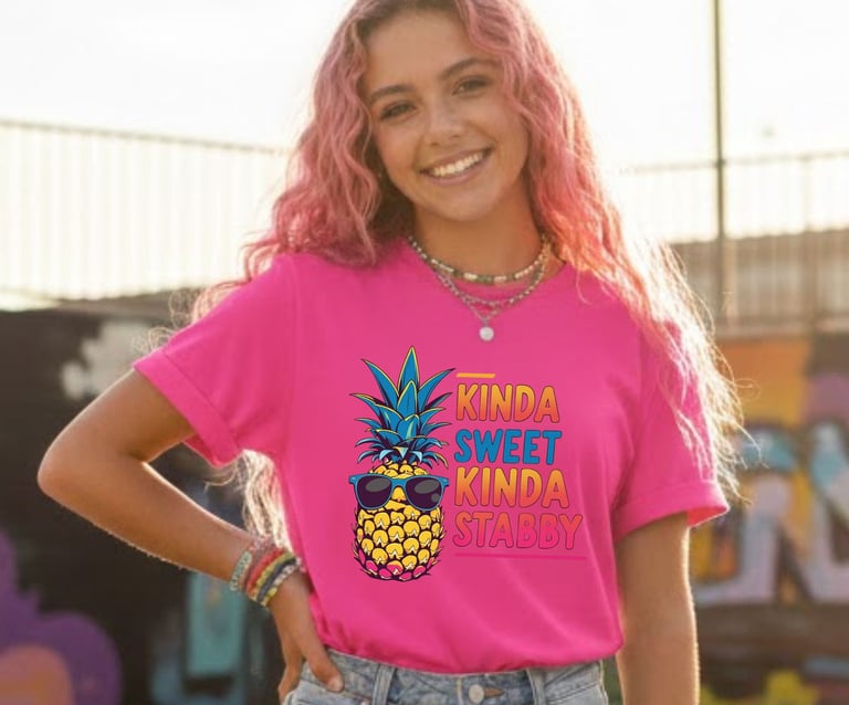 Woman wearing a bright pink t-shirt with a "Kinda Sweet Kinda Stabby" pineapple graphic.