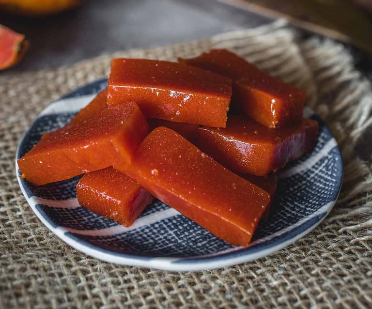 a plate with slices of pink guava paste