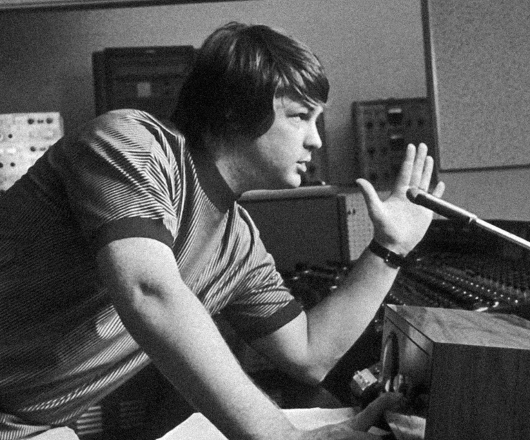 Brian Wilson of the Beach Boys works at a vintage mixing console in a recording studio.