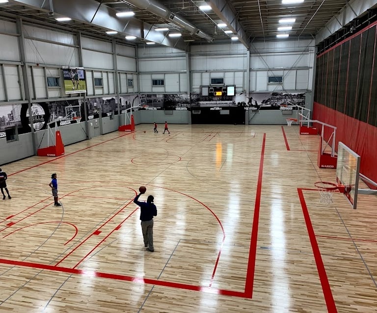 a man standing on a basketball court with a ball