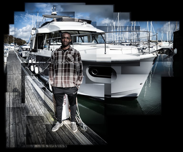 A photo joiner of Ini standing next to a yacht