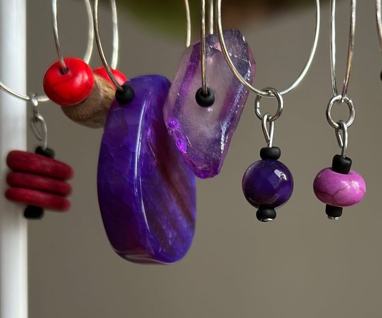 assorted purple gemstone wine charms