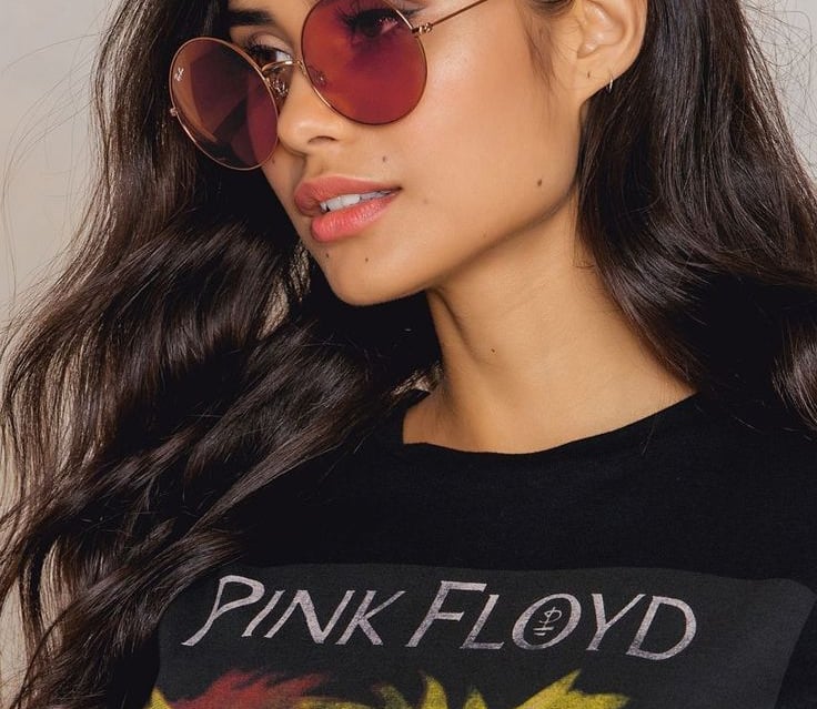 a woman wearing a black shirt and sunglasses