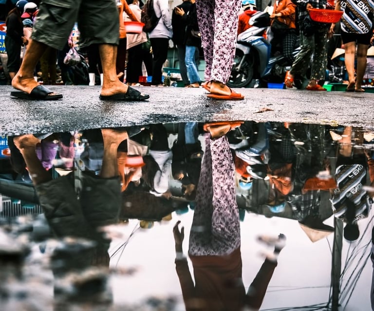 Reflection of Vietnamese lady on the street