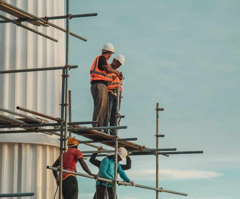 a group of men standing on scaffolding scaffolding