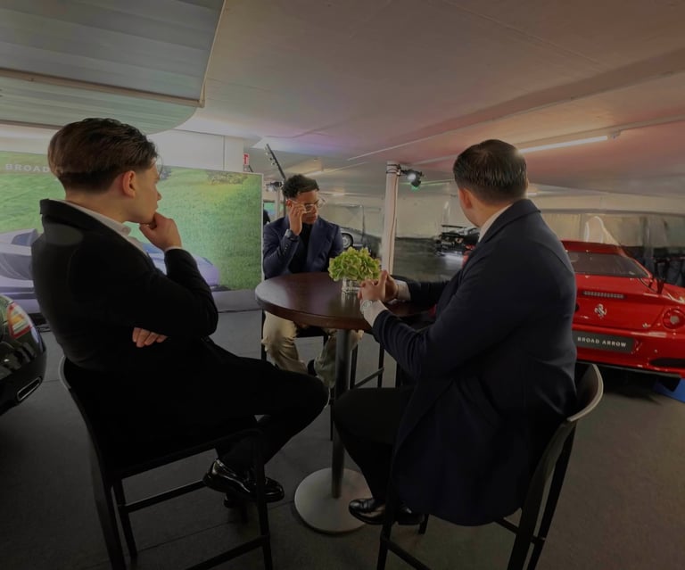 Well-dressed man inside a luxury car focused on planning and execution rather than consumption