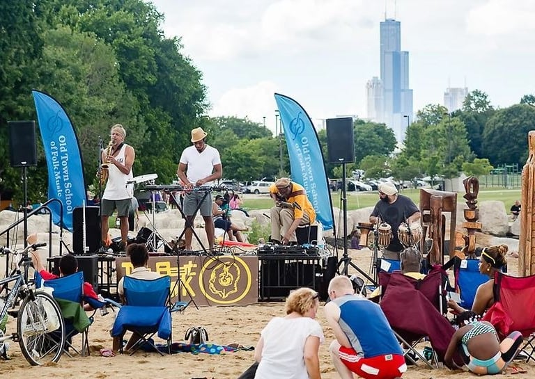 Musical performance on the beach in Chicago with saxaphonist, guitarist and DJ