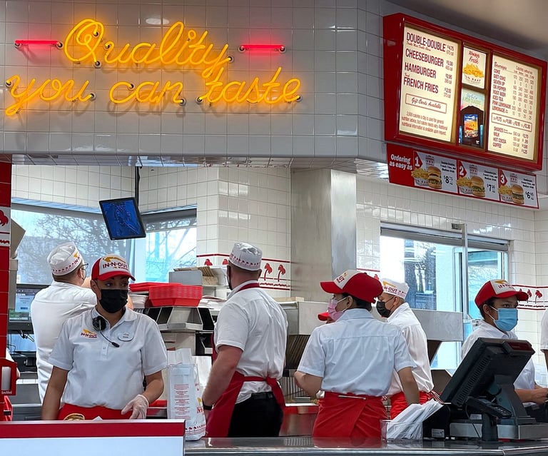 Busy fast food restaurant with customers in line at the counter
