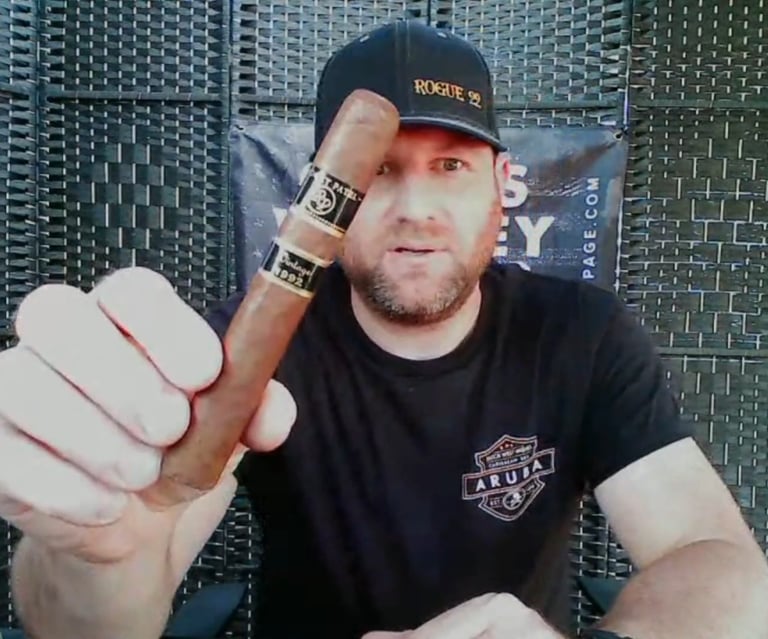 a man in a black shirt and a cigar