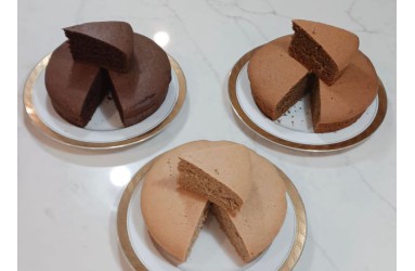 Gluten free cakes by Only Oats with a slice cut from each in chocolate and vanilla.