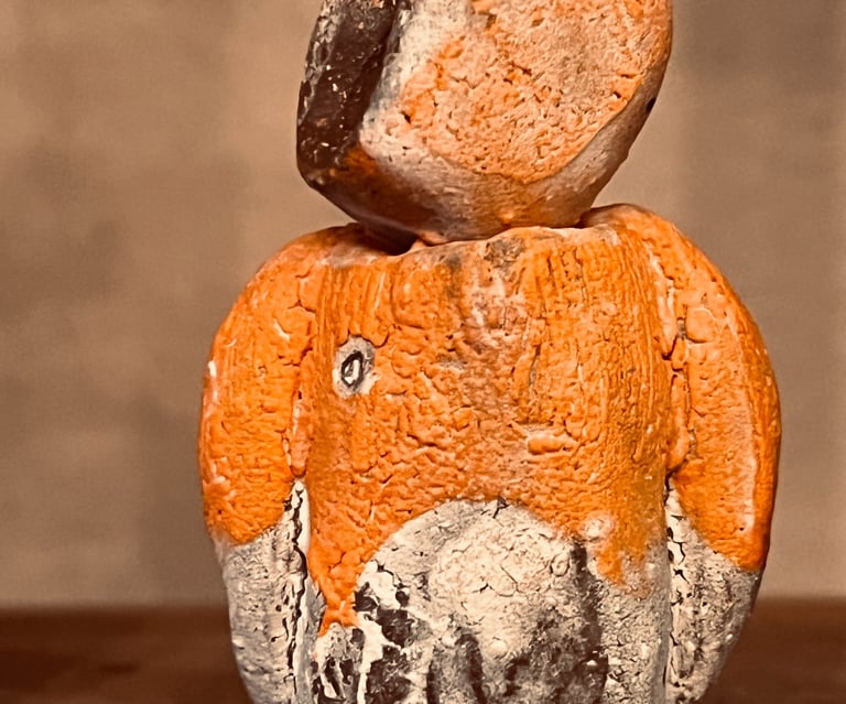 Handcrafted orange and charcoal ceramic totem sculpture with a textured rustic finish by Sundara