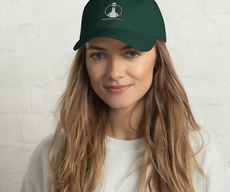 A woman wearing a dark green baseball cap with the Silly Goose Recordings logo.