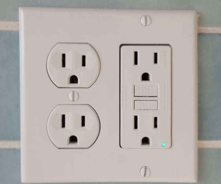A white four plug outlet with a GFCI on the right 
