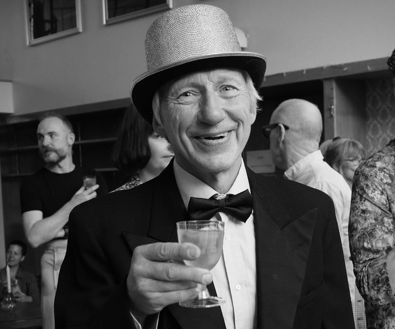 a man in a tuxedo and hat.