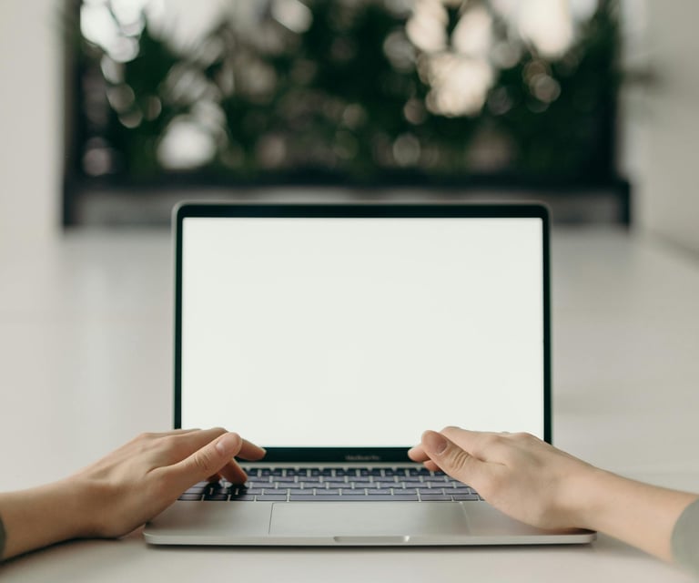 image shows hands typing on a laptop