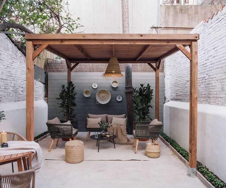 Outdoor terrace with seating and green plants, offering a serene atmosphere in Barcelona apartment