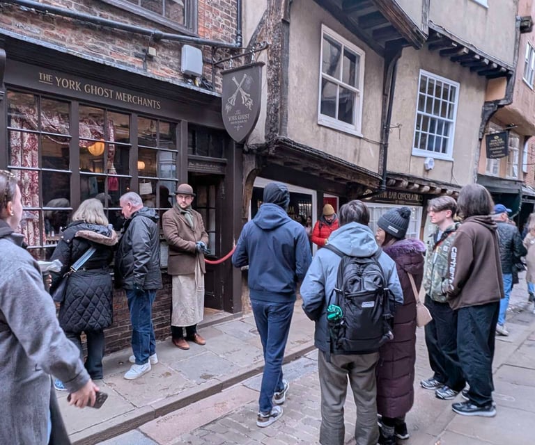 people waiting to in a shop  in the shambles in York
