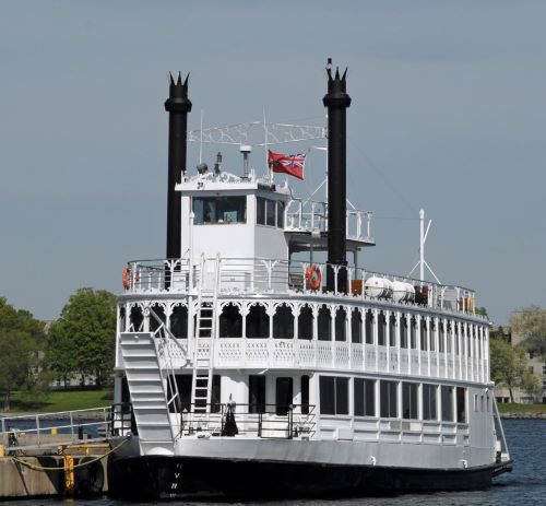 a large white boat with a flag on it