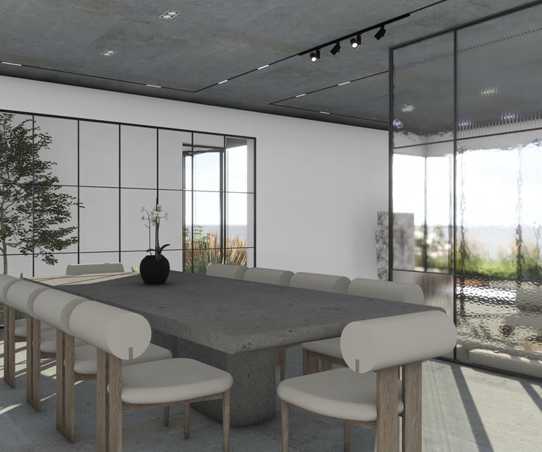 Large concrete dining table and modern chairs with light upholstery illuminated by track lighting