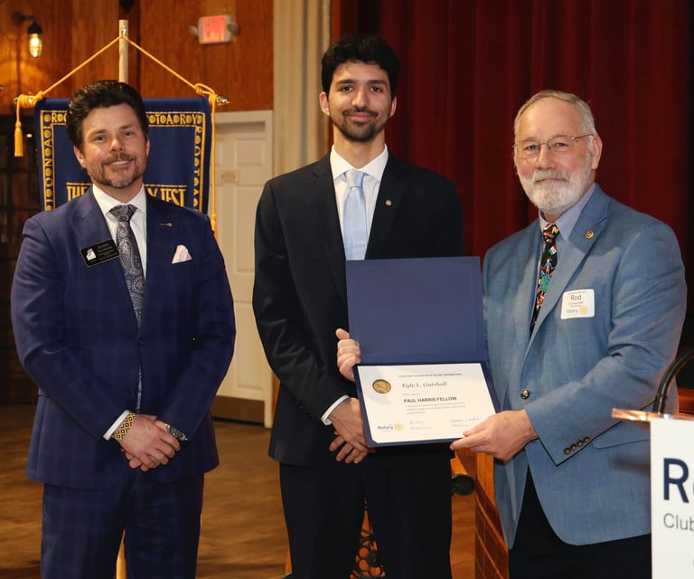 Kyle Gutshall receiving Paul Harris Fellow Award at the Woodstock Rotary's 100th Anniversary Dinner