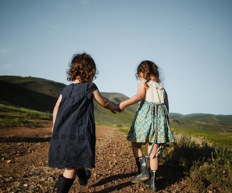 two girls helping each other while wlaking hand in hand
